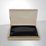 Luxurious black silk pillowcase from SilkSleek in elegant packaging for restful sleep