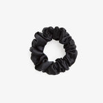 Black silk scrunchie on a white background