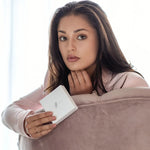 Woman holding a silk scrunchies in SilkSleek Branded white box 