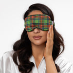 Woman wearing a plaid sleep mask on a white background