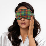 Woman wearing a plaid sleep mask on a white background