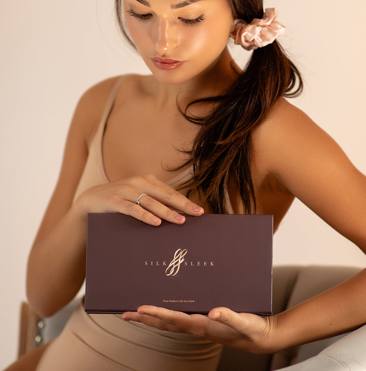 Woman holding a 'SilkSleek' Gift  box