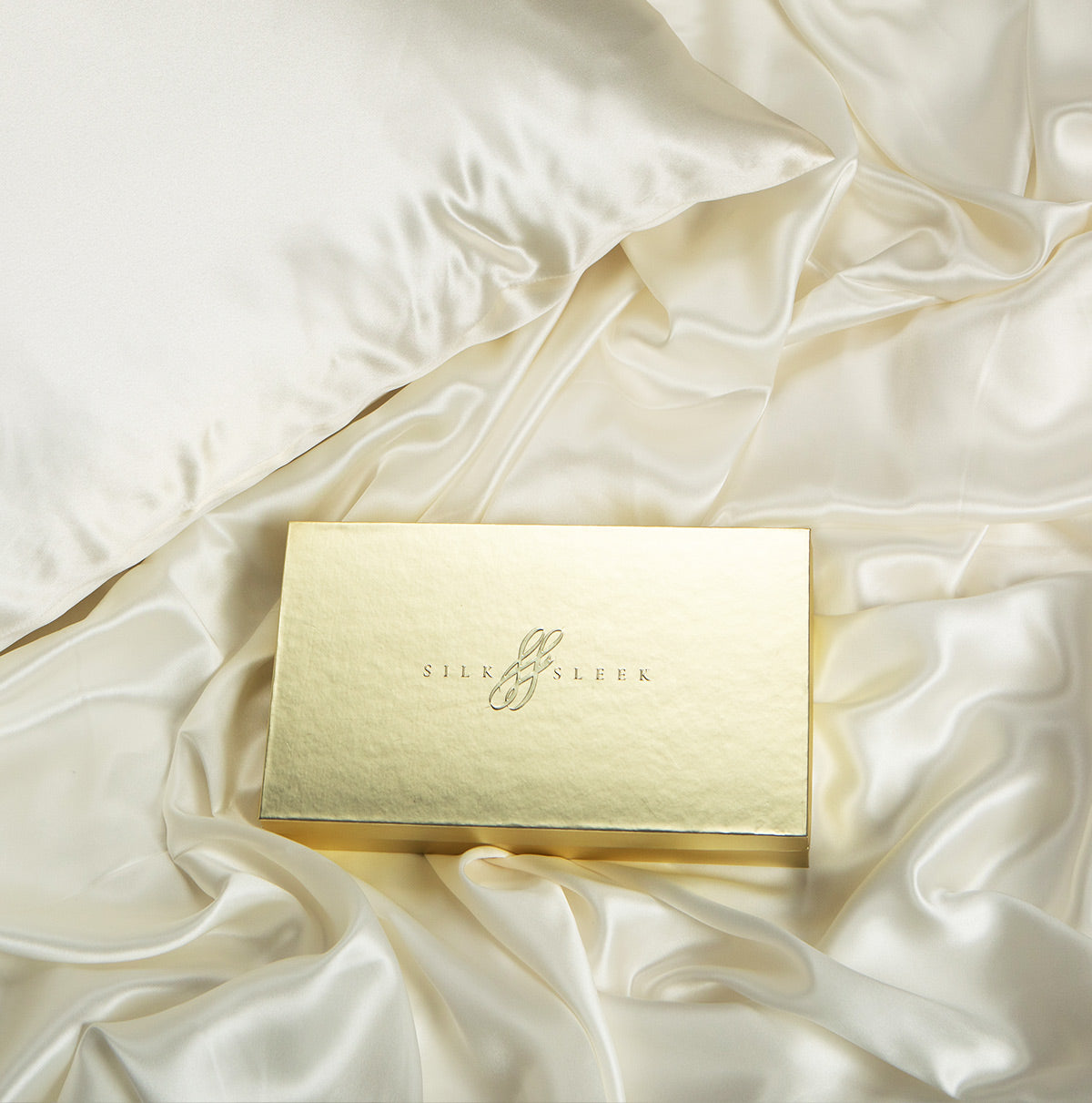SilkSleek luxury gift box displayed on mulberry silk fabric with pillowcase perfect for elegant gifting and self-care