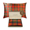 Plaid patterned pillow with a visible brand label on a white background