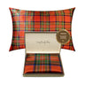 Plaid patterned pillow with a visible brand label on a white background