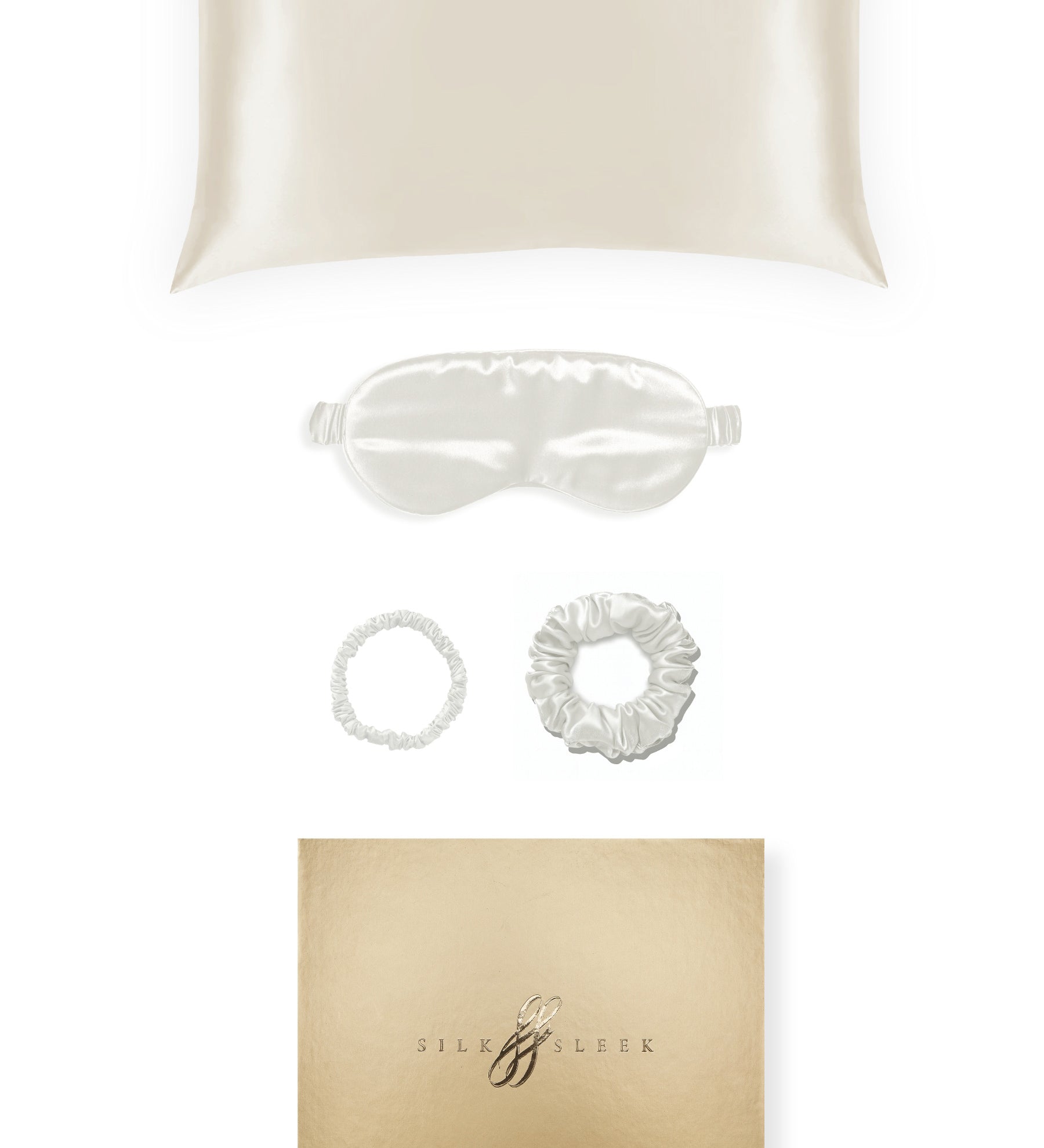 Silk pillowcase, eye mask and hair ties displayed on a white background beside a gold gift box.